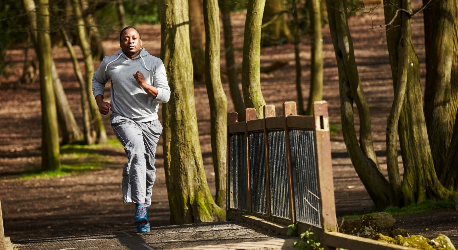 Man running through forest - credit: World Obesity Federation